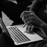 Digital Business - grayscale photo of person using MacBook