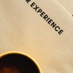 Customer Experience - A Top Shot of a Cup of Coffee on Brown Envelopes