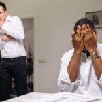 Workplace Conflict - Man in White Dress Shirt Covering His Face