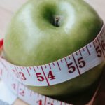 Product-Market Fit - Green apple with measuring tape on table in kitchen