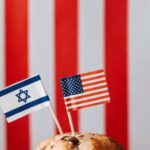 Global Trade Agreements - Tasty muffin with national flags of USA and Israel